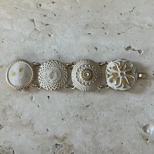 YSL Yves Saint Laurnet four disc enamel white and gold bracelet w original box.